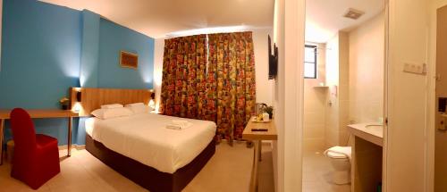 a hotel room with a bed and a bathroom at HOTEL ORKID PORT KLANG in Klang