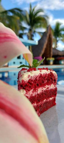 a piece of red velvet cake sitting on a table at Hotel Campestre San Joaquin in Garzón