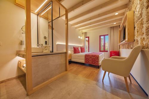 a bathroom with a sink and a bedroom at Fil Suites in Palma de Mallorca
