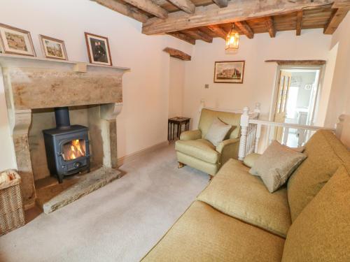 a living room with a fireplace and a couch at Billy Whiskey's in Tideswell