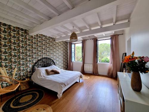 a bedroom with a bed with a person laying on it at Les Granges de Jules in Lafitte-Vigordanne