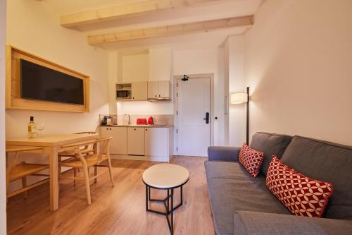 a living room with a couch and a table at Fil Suites in Palma de Mallorca