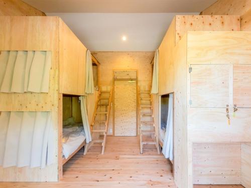 a room in a tiny house with bunk beds at Famale Only Dormitory Guest House Amami Long Beach2 Vacation STAY 37994v in Amami