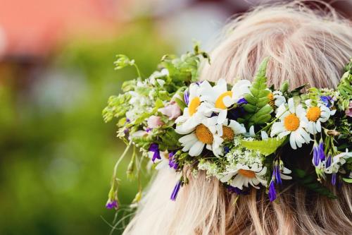 a woman with a flower crown on her head at First Camp Moraparken - Dalarna in Mora