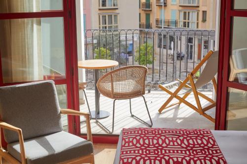 a balcony with chairs and a table and a table at Fil Suites in Palma de Mallorca