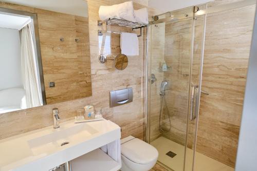 a bathroom with a toilet and a sink and a shower at Grupotel Orient in Playa de Palma