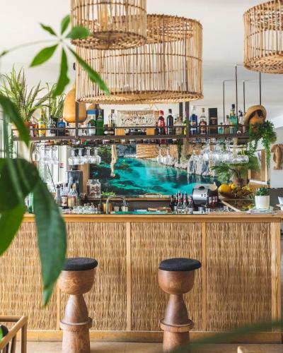 a bar with a pool mural on the wall at Hotel de La Plage - Mahogany in Cassis