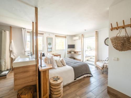 a bedroom with a bed and a sink at Hotel de La Plage - Mahogany in Cassis