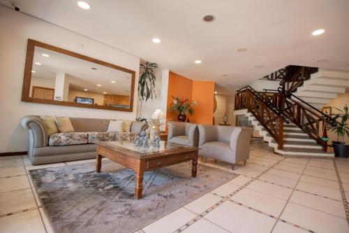 a living room with a couch and a table at Ilha Flat Hotel Suíte Bella - 4207 - Ilhabela in Ilhabela