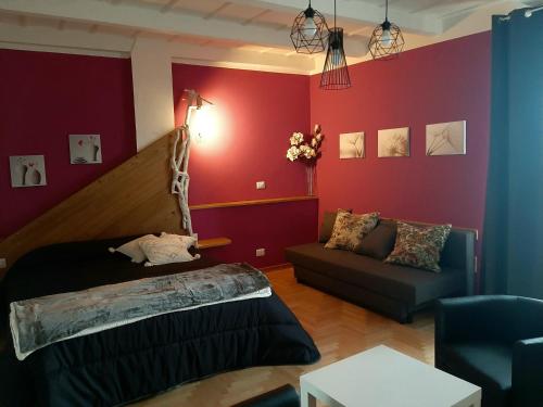 a living room with a bed and a couch at B&B degli Allori in Moggiona