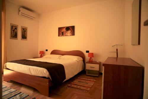 a bedroom with a large bed and a night stand at La Torre in Tirano