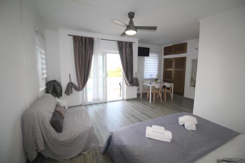 a bedroom with a bed and a living room at Casa do Milho in Carvoeiro