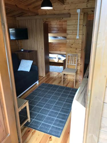 a room with a bed and a desk and a chair at Rybacka 48 - Twoje miejsce wypoczynku, domki, studia, apartamenty, rowery, hulajnogi in Jantar