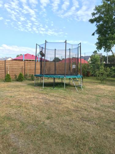 a large trampoline in a yard with at Rybacka 48 - Twoje miejsce wypoczynku, domki, studia, apartamenty, rowery, hulajnogi in Jantar