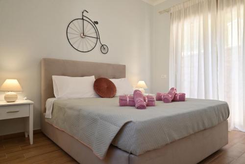 een slaapkamer met een bed met roze knuffels erop bij Villa Ioanna in Liapades