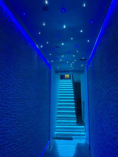 a blue corridor with stairs in a building at B&B Vittorio Emanuele in Licata