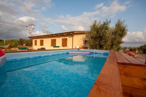 a swimming pool in front of a house at Agriturismo L'Istrice di Giò in Montalto di Castro