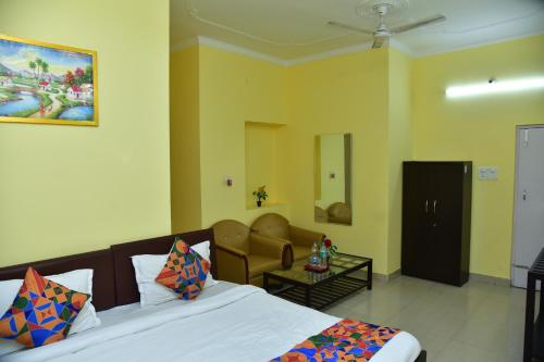 a bedroom with a bed and a living room at Samriddhi Stay Inn in Lucknow