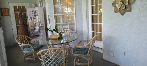 a dining room with a glass table and chairs at Charming Country Retreat Home in Clermont