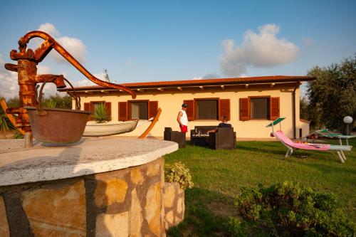 a man standing in front of a house at Agriturismo L'Istrice di Giò in Montalto di Castro