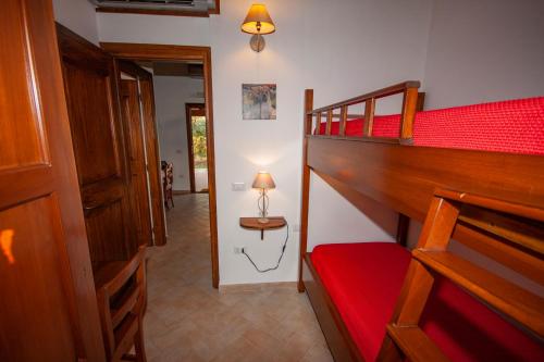 a room with two bunk beds and a table with a lamp at Agriturismo L'Istrice di Giò in Montalto di Castro