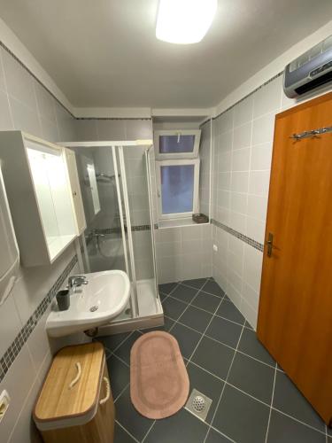 a bathroom with a sink and a toilet at Apartments Mora Cantada in Piran