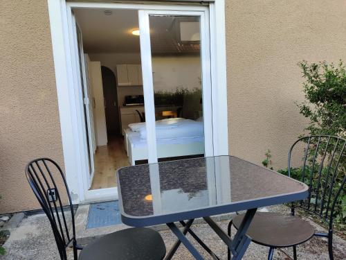 a table and chairs on a patio with a bedroom at Schicke Wohnungen in Stadtnähe in Würzburg