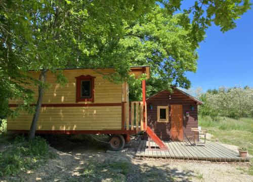 a tiny house on a truck under a tree at Kerca Bio Farm in Kercaszomor