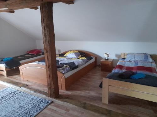 two beds in a room with wooden floors at Pokoje gościnne-Głotowo in Dobre Miasto