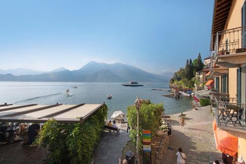 a view of a body of water with people on a beach at Casa Giada in Varenna