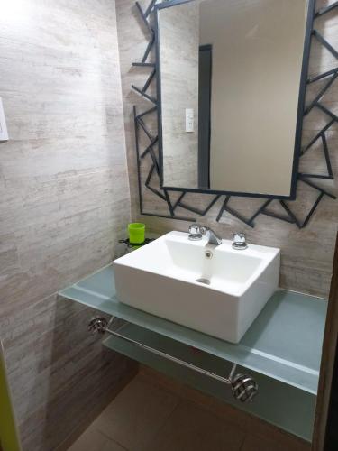 a bathroom with a white sink and a mirror at Alto de Balcon B in Tanti