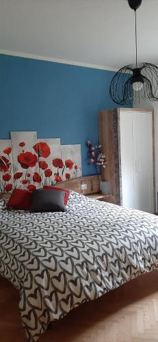 a bedroom with a large bed with a blue wall at B&B degli Allori in Moggiona
