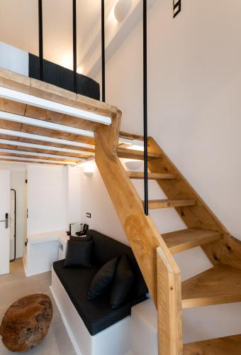 a staircase in a loft conversion with a bench underneath it at Ryous Mykonos in Mýkonos City