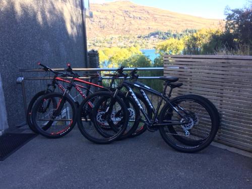 a group of bikes parked next to a wall at Luxury Lakeside Studio in Queenstown