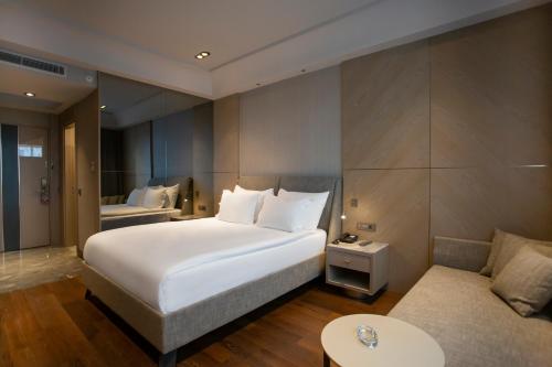 a hotel room with a bed and a couch at Melas Hotel Istanbul in Istanbul