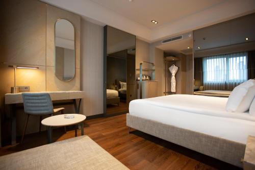 a hotel room with a large bed and a desk at Melas Hotel Istanbul in Istanbul