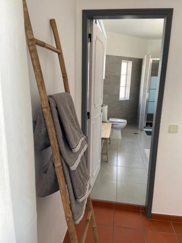 a ladder leaning against a bathroom with a towel at Guesthouse Releash Aljezur in Aljezur