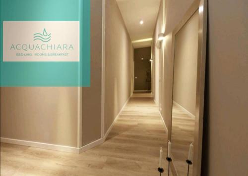 a corridor in a building with a sign on the wall at Villa ACQUACHIARA ISEO Bed & Breakfast ISEO CENTER with PARKING inside Foresteria in Iseo