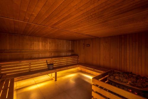 a large empty sauna with a bucket in the middle at Holiday Inn Yerevan - Republic Square by IHG in Yerevan