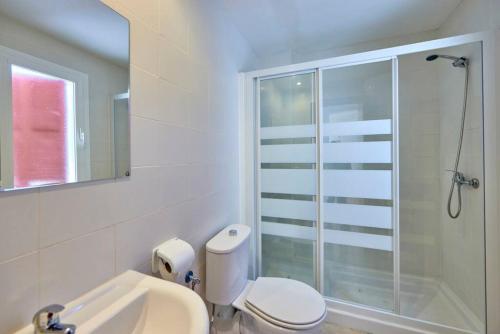 a bathroom with a shower and a toilet and a sink at Nura Houses Duplex Magaluf 5 in Magaluf