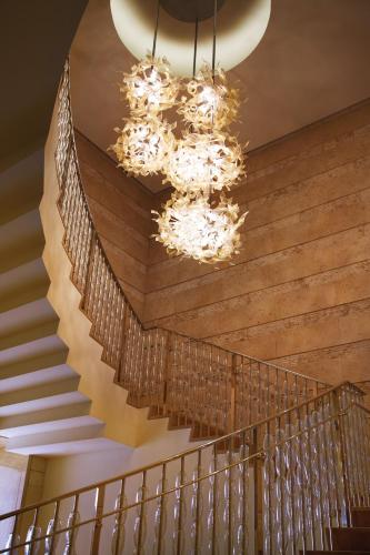 a staircase in a building with a chandelier at Four Seasons Baltimore in Baltimore