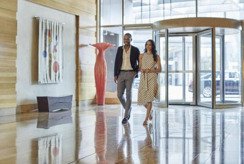 a man and a woman walking down a hallway at Four Seasons Baltimore in Baltimore