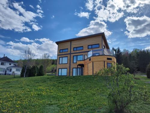 a house on top of a grassy hill at Auberge country inn in Baie-Saint-Paul