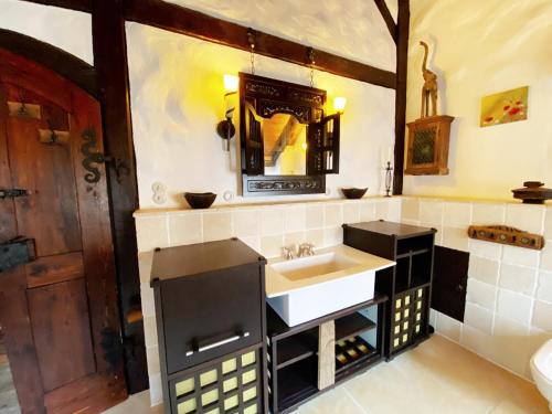 a bathroom with a sink and a mirror and a counter at Ferienhaus NAMIBIA-LODGE im Rittergut Leppersdorf bei Dresden in Wachau