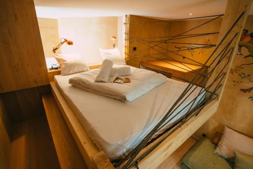 a bedroom with a bunk bed with a cat laying on it at Domaine Bohème I art de vivre in Guebwiller