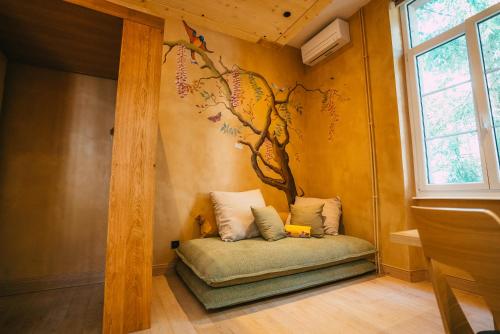 a small room with a tree mural on the wall at Domaine Bohème I art de vivre in Guebwiller