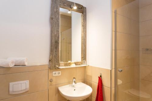 a bathroom with a sink and a mirror at Gasthof zum Hirsch in Görisried
