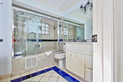 a bathroom with a toilet and a shower and a sink at Sugar Sands C in St Pete Beach