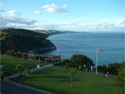 a view of the ocean from a park with a flag at Seabreeze in Torquay
