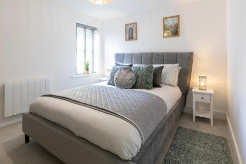 a bedroom with a large bed with pillows on it at The Courtyard- Free evening parking in Southampton